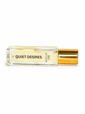 Quiet Desires roll-on perfume oil by E&A Signature Scent Co on a white background, luxury travel-size fragrance oil for women with raspberry, strawberry, cherry, jasmine, musk, amber, and woods notes.